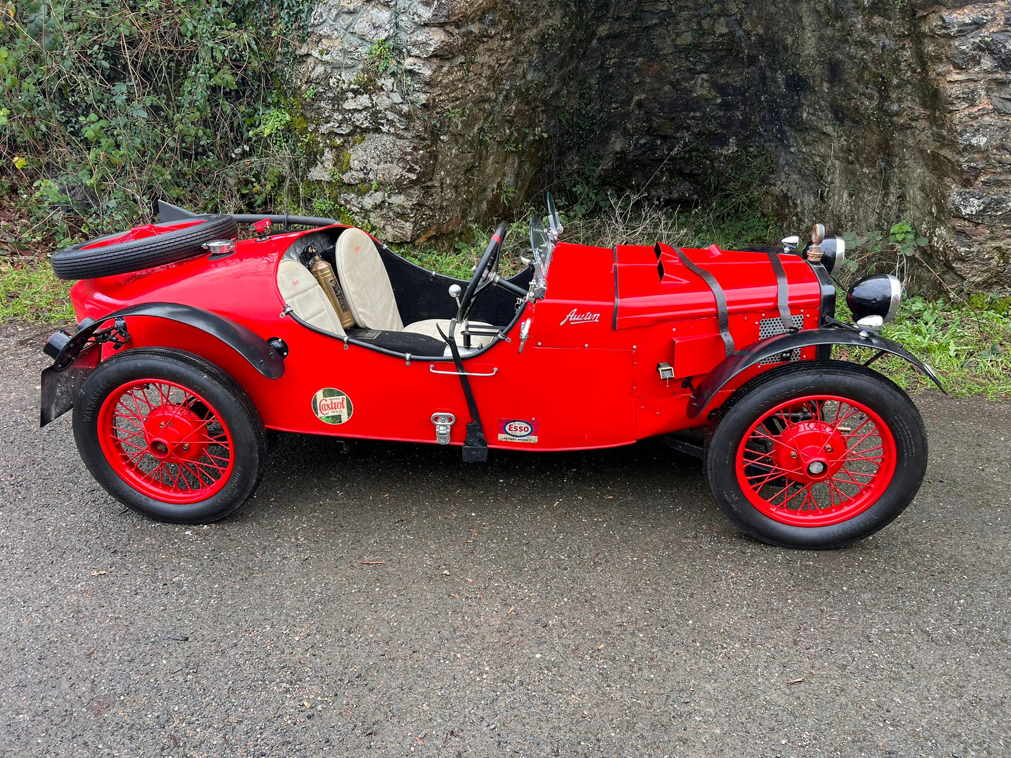Austin 7 Special side profile against a stone wall